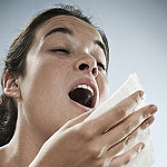 lady about to sneeze into a tissue
